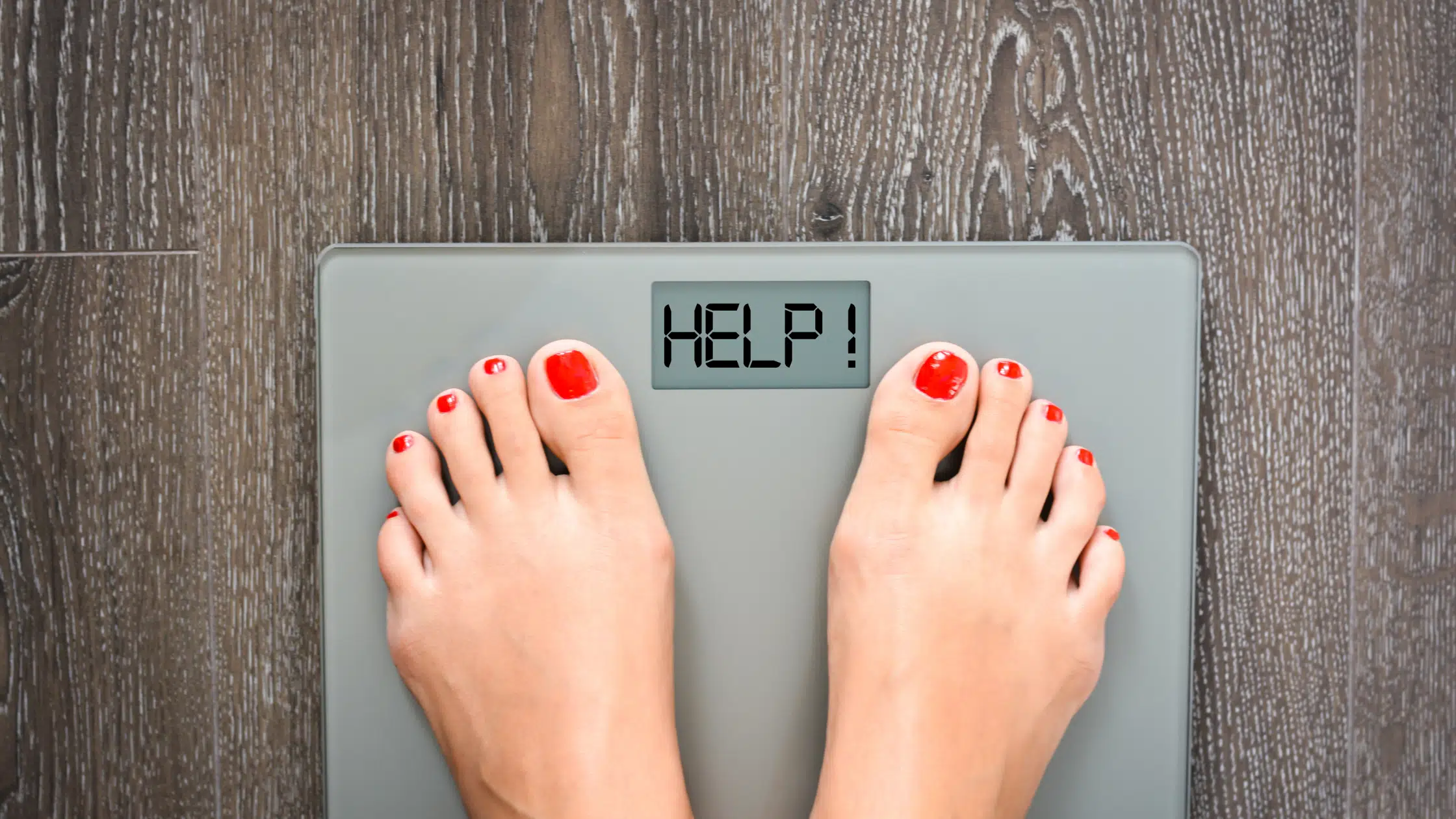 woman standing on weight scale